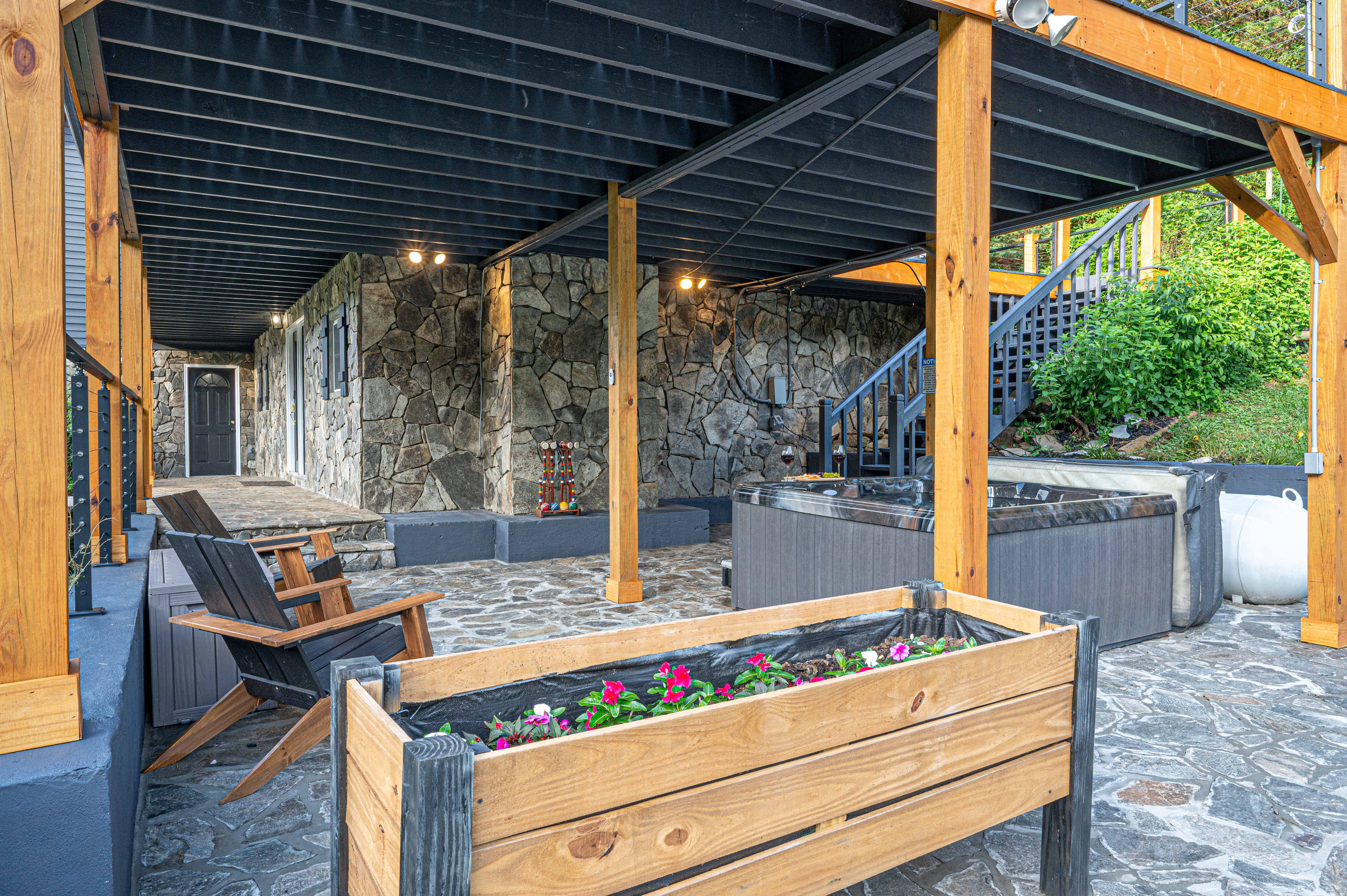 Outdoor Oasis: Relax on the stone patio surrounded by nature and soak in the hot tub!