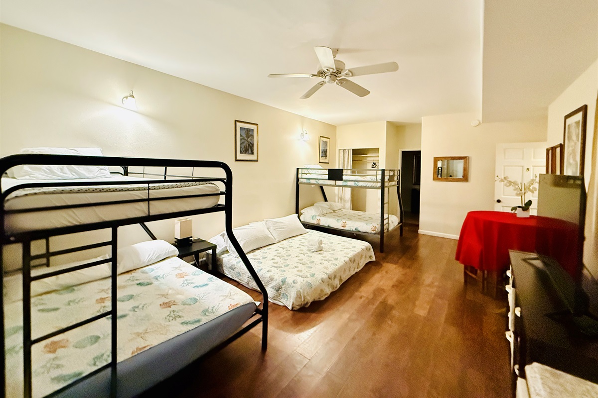 Bedroom 5 with two twin over full bunk beds and a full bed