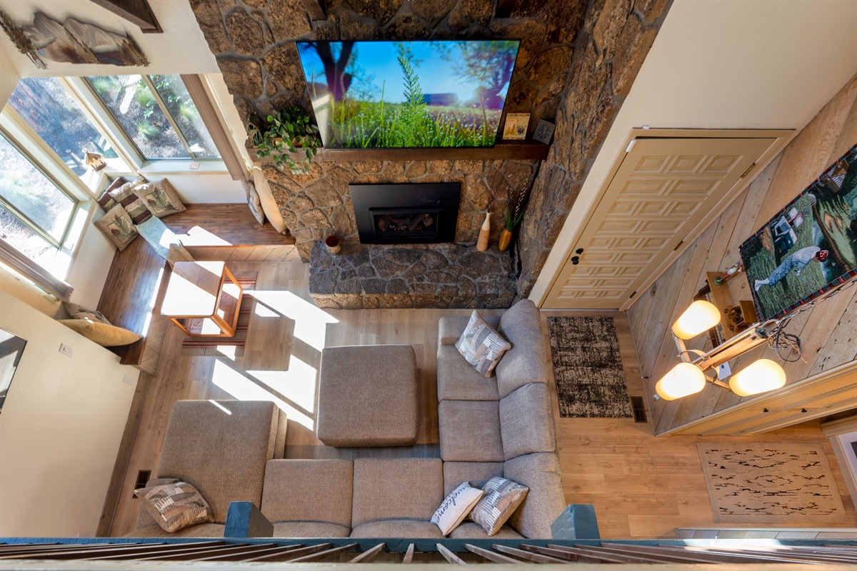 The living room is warm and inviting, featuring a gas fireplace that comfortably warms the entire space. 