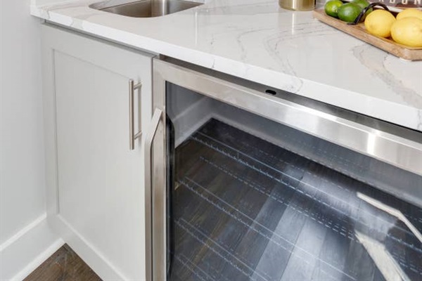 - Sleek under counter beverage cooler keeps your drinks perfectly chilled for any occasion - Modern marble countertop offers a stylish and spacious prep area - Stainless steel finishes and custom cabinetry complete the upscale kitchen vibe