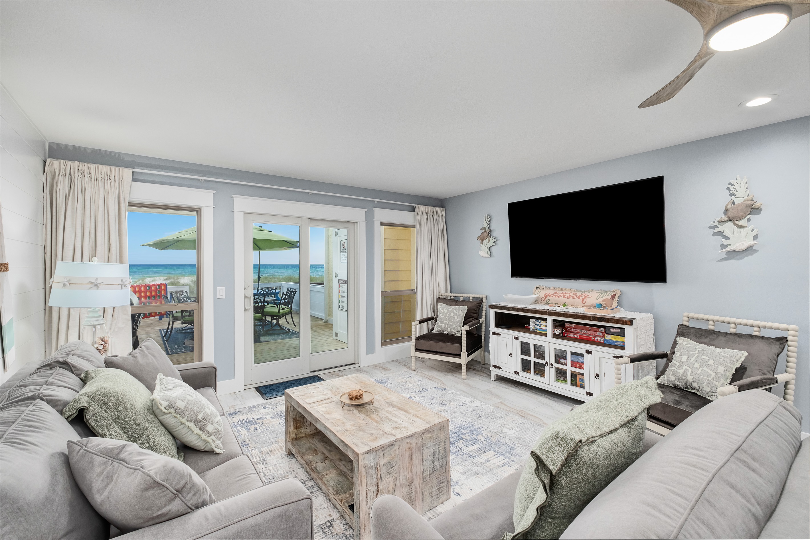 Experience ultimate comfort in this inviting living room with plush seating, a large flat-screen TV, and stunning views of the ocean. Perfect for relaxing with family and friends.
