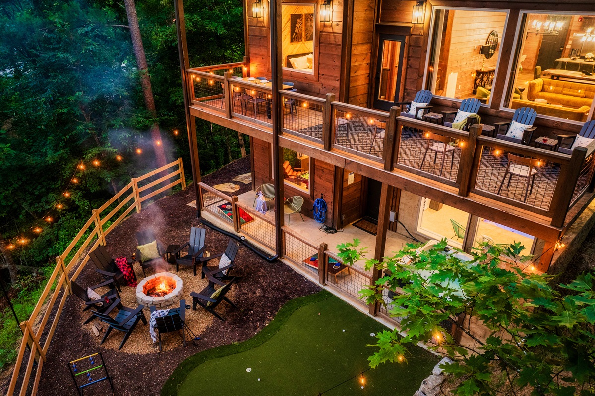 Luxury cabin with multiple decks, outdoor seating, nature views, string, lights, fire pit, mini golf and hot tub