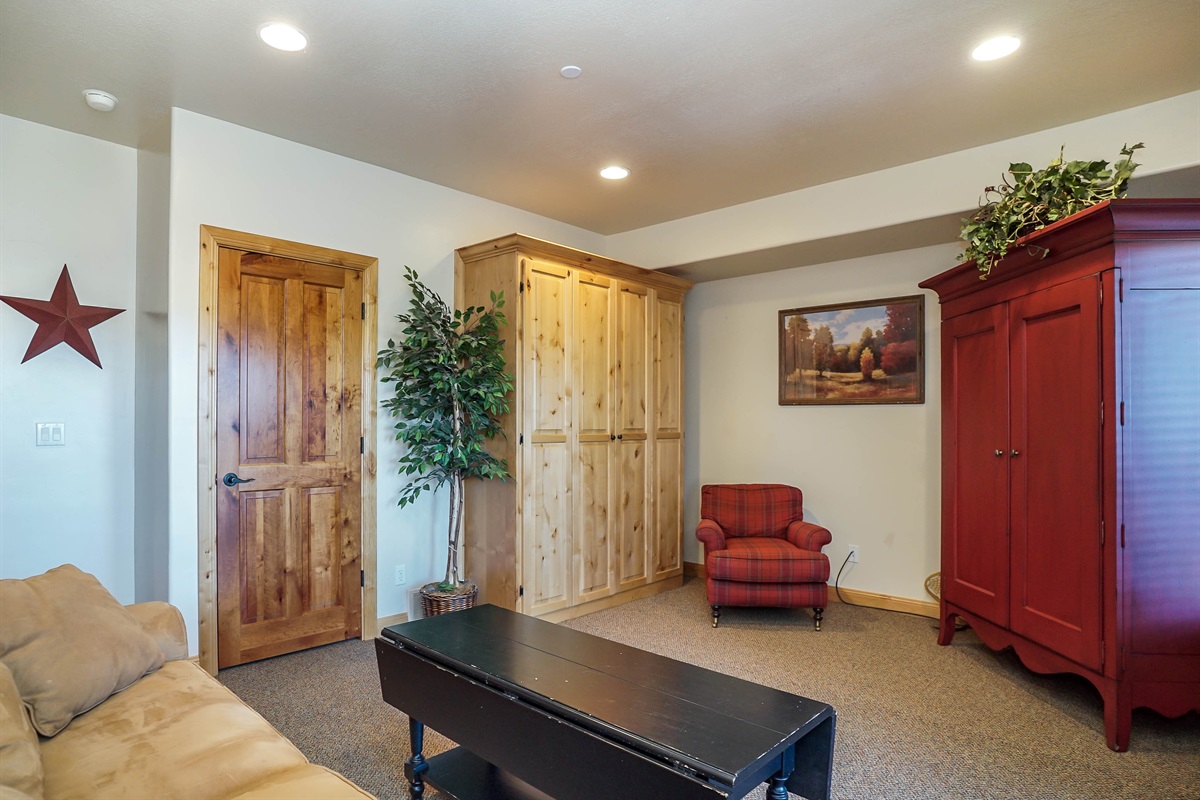 Downstairs living space with cozy seating and rustic décor accents.