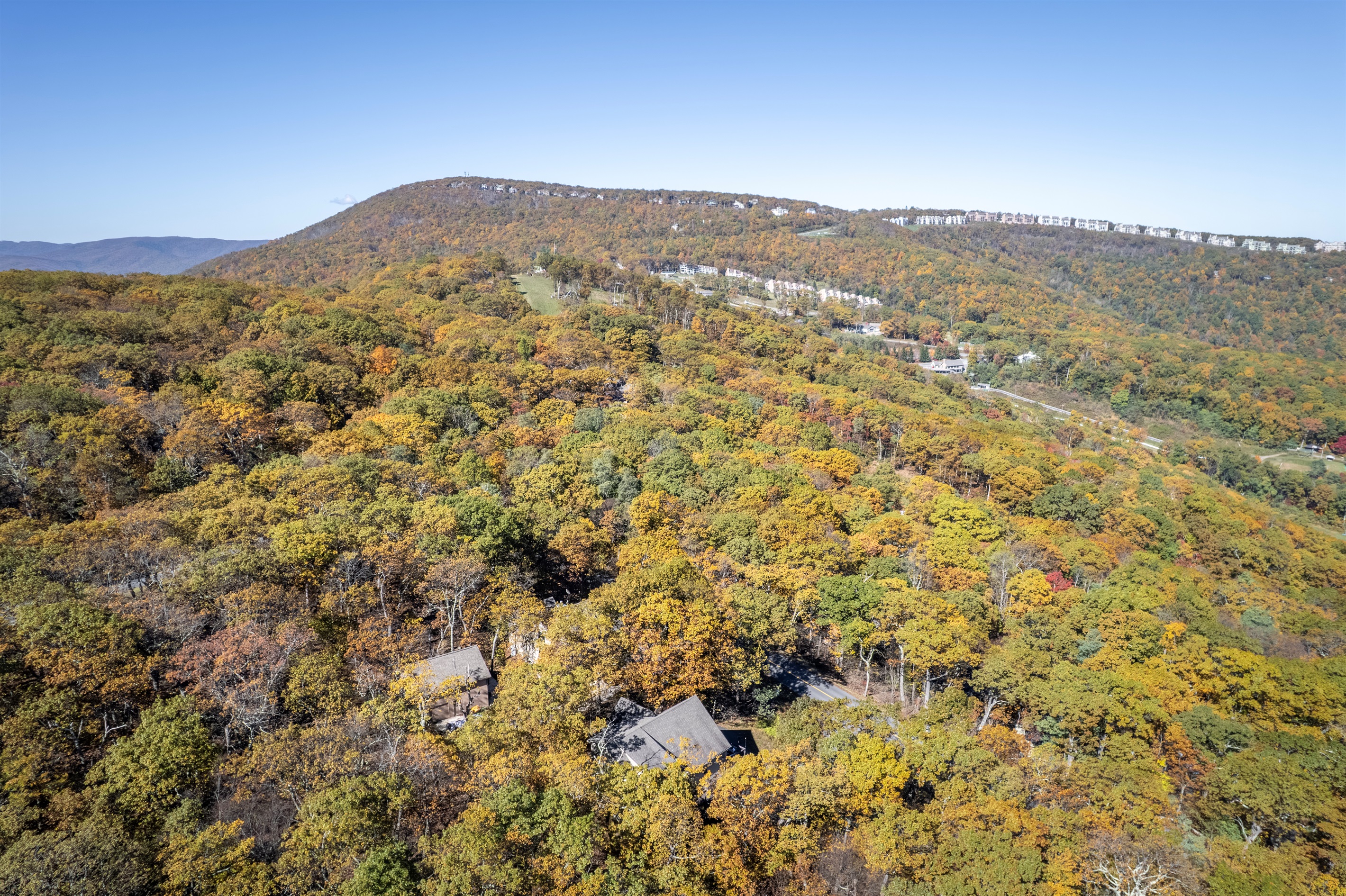 Aerial panorama captures Wintergreen’s golden ridges and forest canopy, revealing a rare view across to the far side of the resort