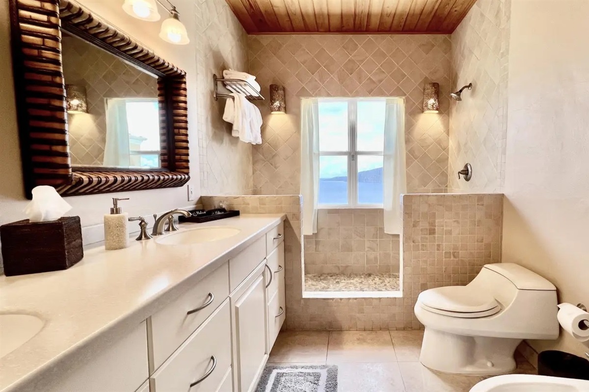 Bright bathroom vanity with plenty of storage, fresh towels, and a large mirror for easy getting ready.
