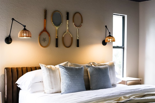 This king bedroom serves up vintage court vibes and extra guest convenience with a stylish vanity station—perfect for morning routines when the bathroom’s booked. Thoughtful touches = smoother group stays