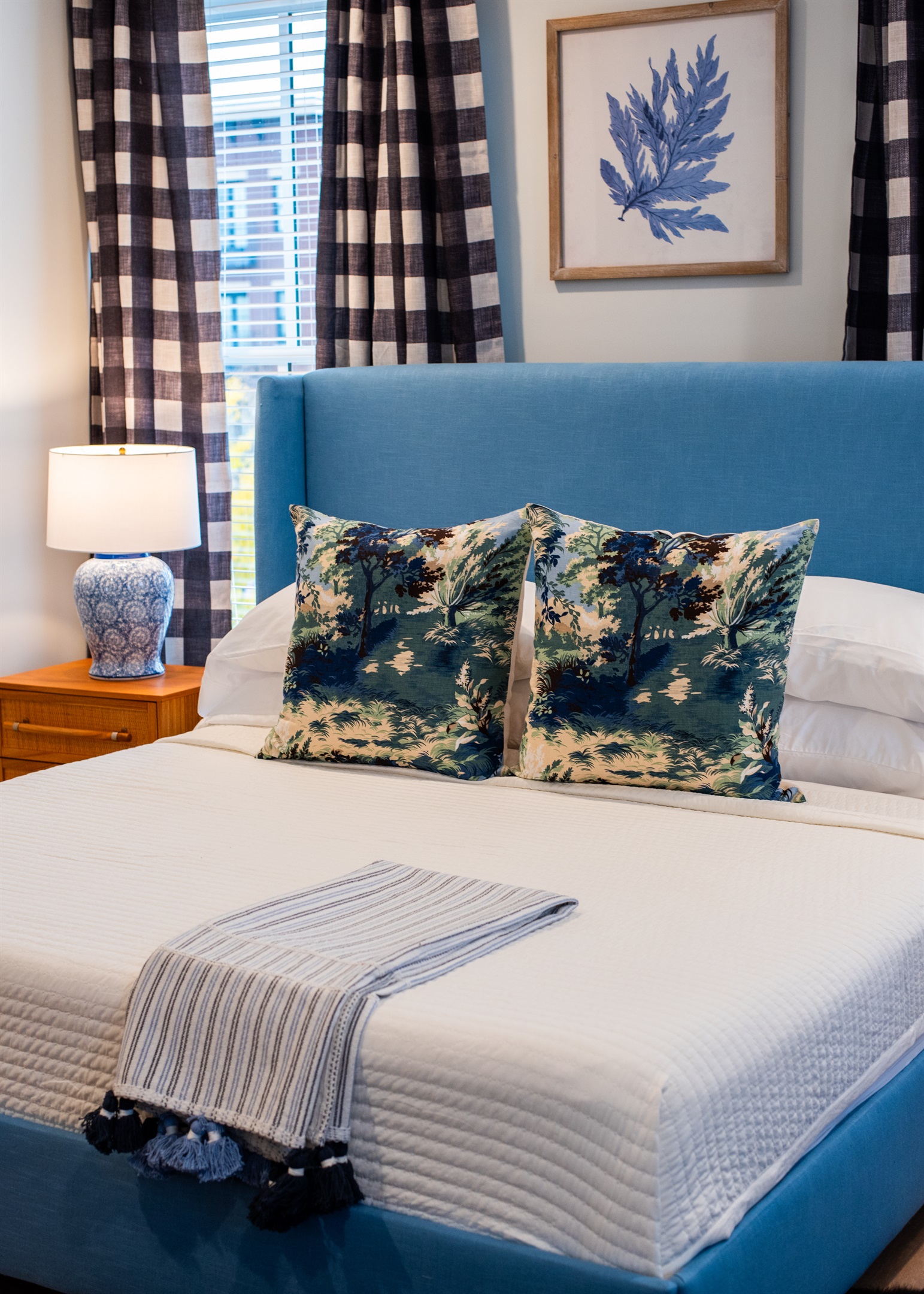 Experience the serene beauty of this tastefully decorated bedroom. With its plush blue headboard, charming decor, and comfy furnishings, it's the perfect retreat for your stay on the Bourbon Trail.