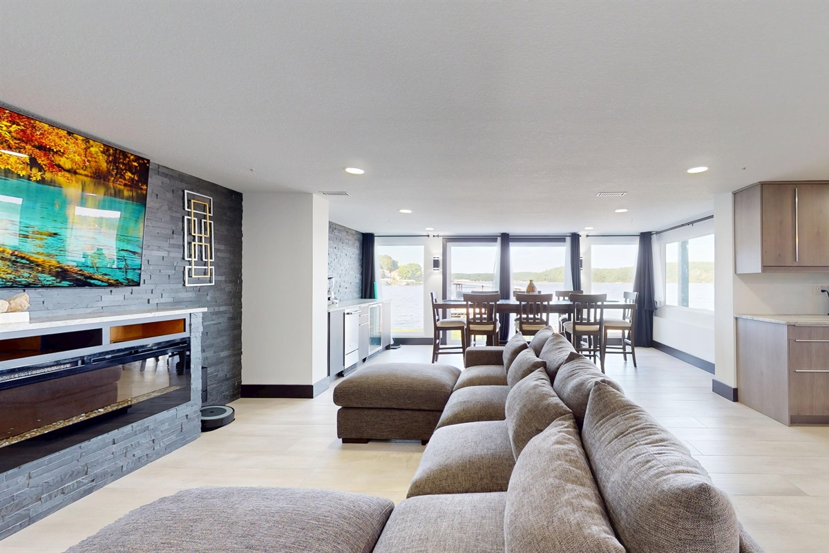 Enjoy The Grand View Lakehouse in all four seasons with an electric fireplace and big open spaces to view the lake as well as that important game on this 85" SmartTV.