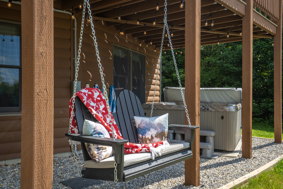 Slow down and enjoy quiet moments on the Adirondack swing, where comfort meets the beauty of nature.