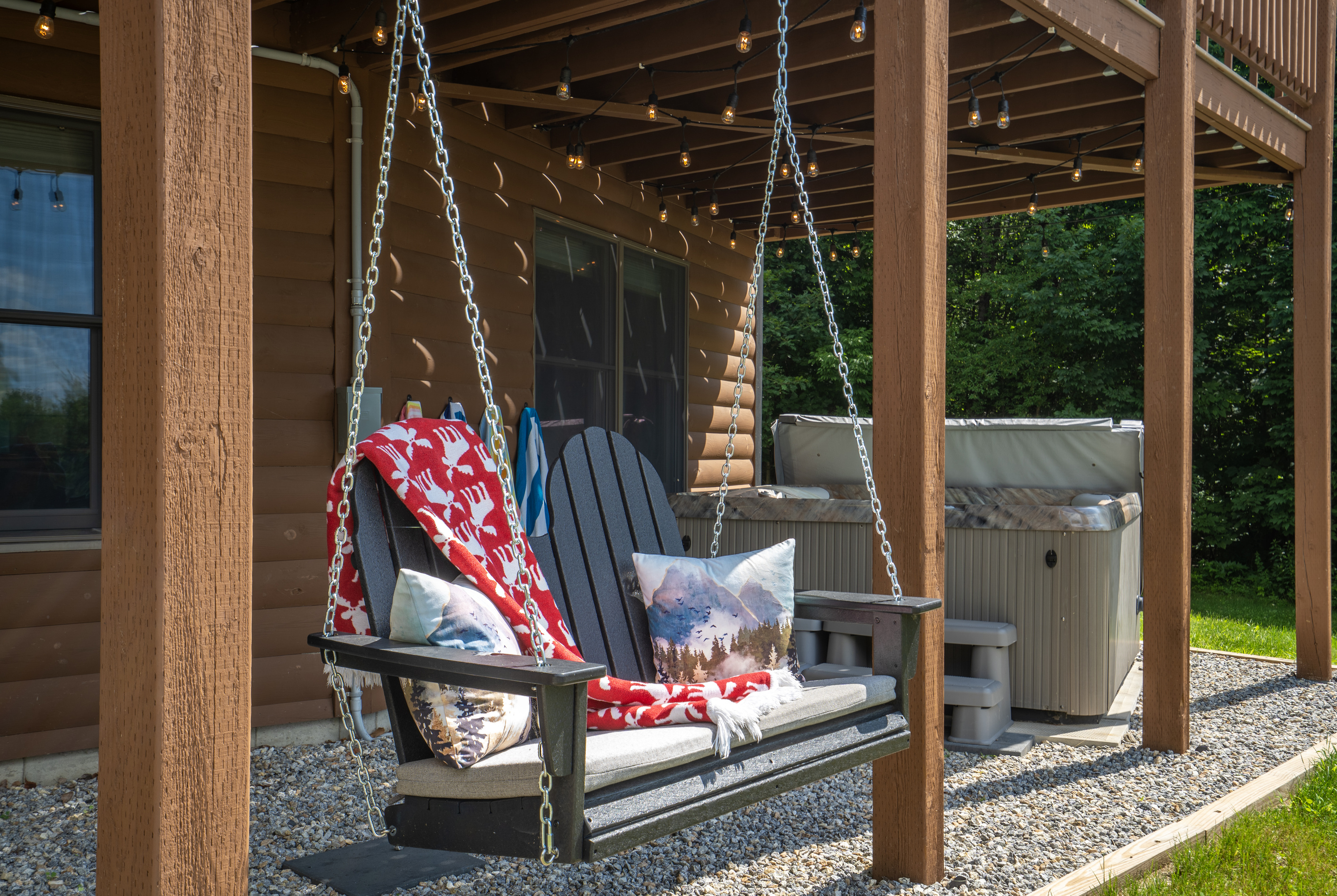 Slow down and enjoy quiet moments on the Adirondack swing, where comfort meets the beauty of nature.