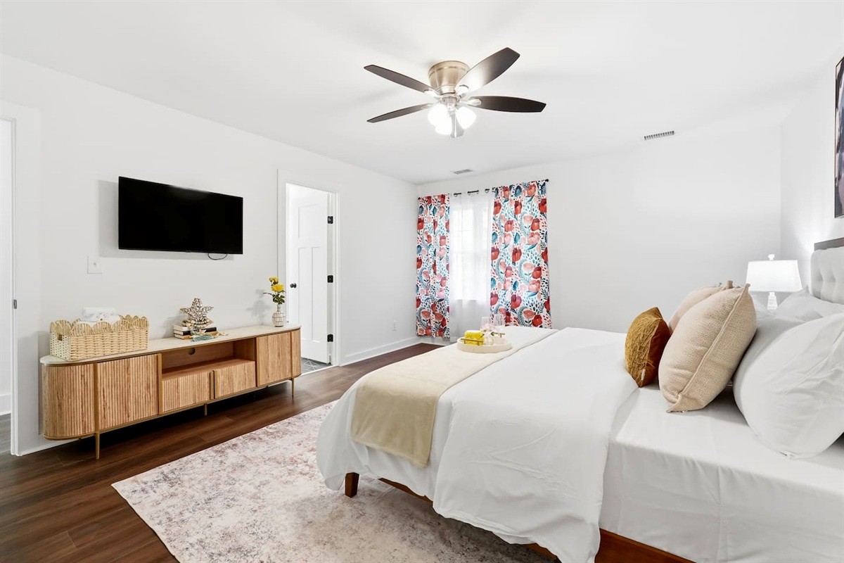 Cozy second-level bedroom featuring a king bed, a Roku-powered Smart TV, and located at the end of the hallway to the left at the top of the staircase. This room includes 2 full-body towels, 2 washcloths, and 2 hand towels for your stay.