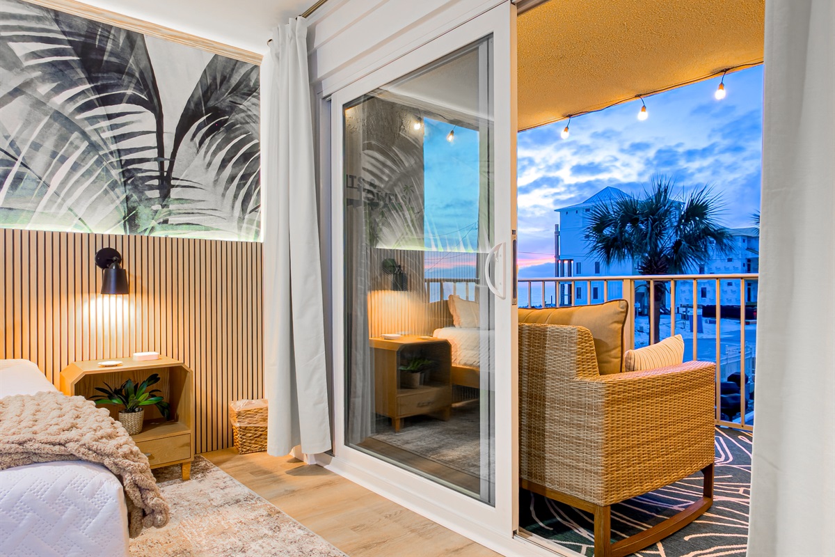 Watch the sky change colors at dusk through the large glass doors. The soft string lights outside create a peaceful evening mood.