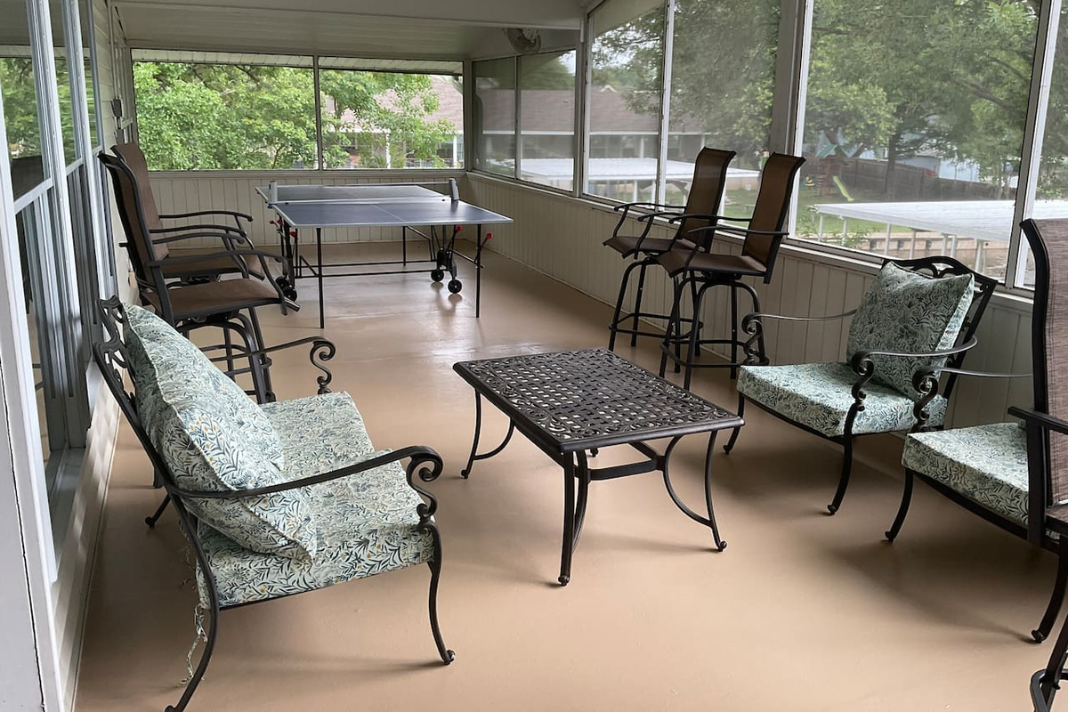 Ping pong and seating on upstairs screened in porch