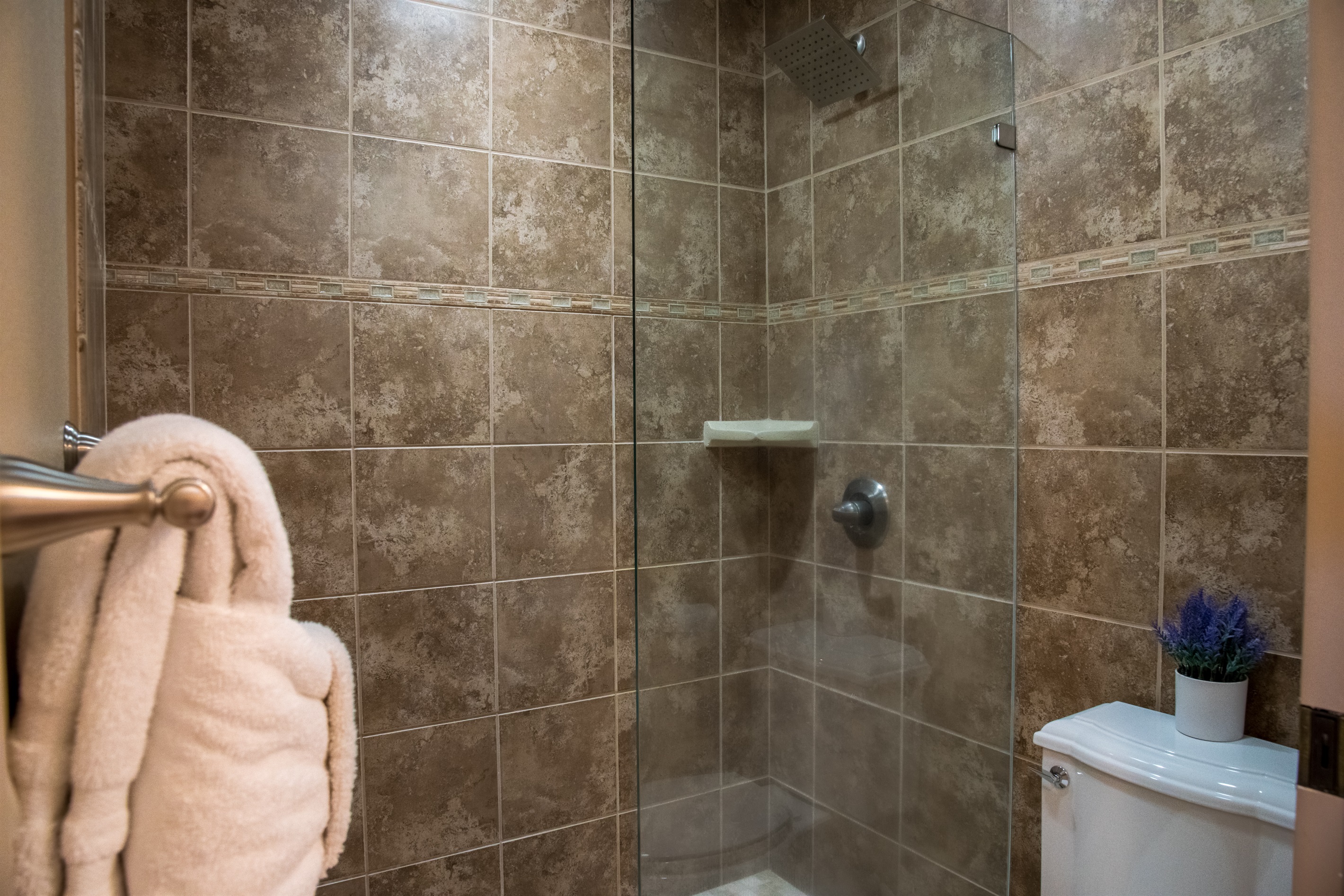 Tiled shower in primary bathroom