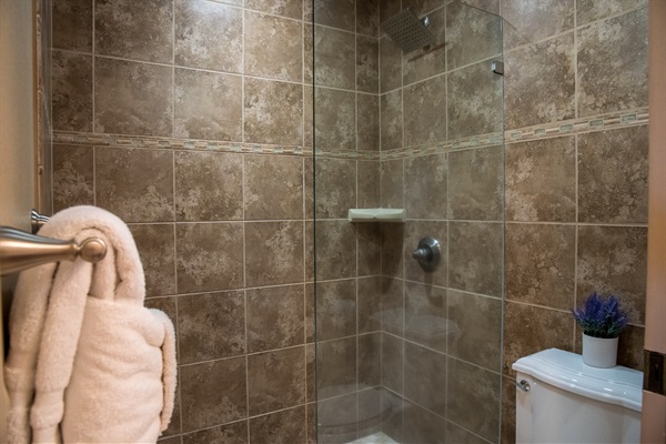 Tiled shower in primary bathroom