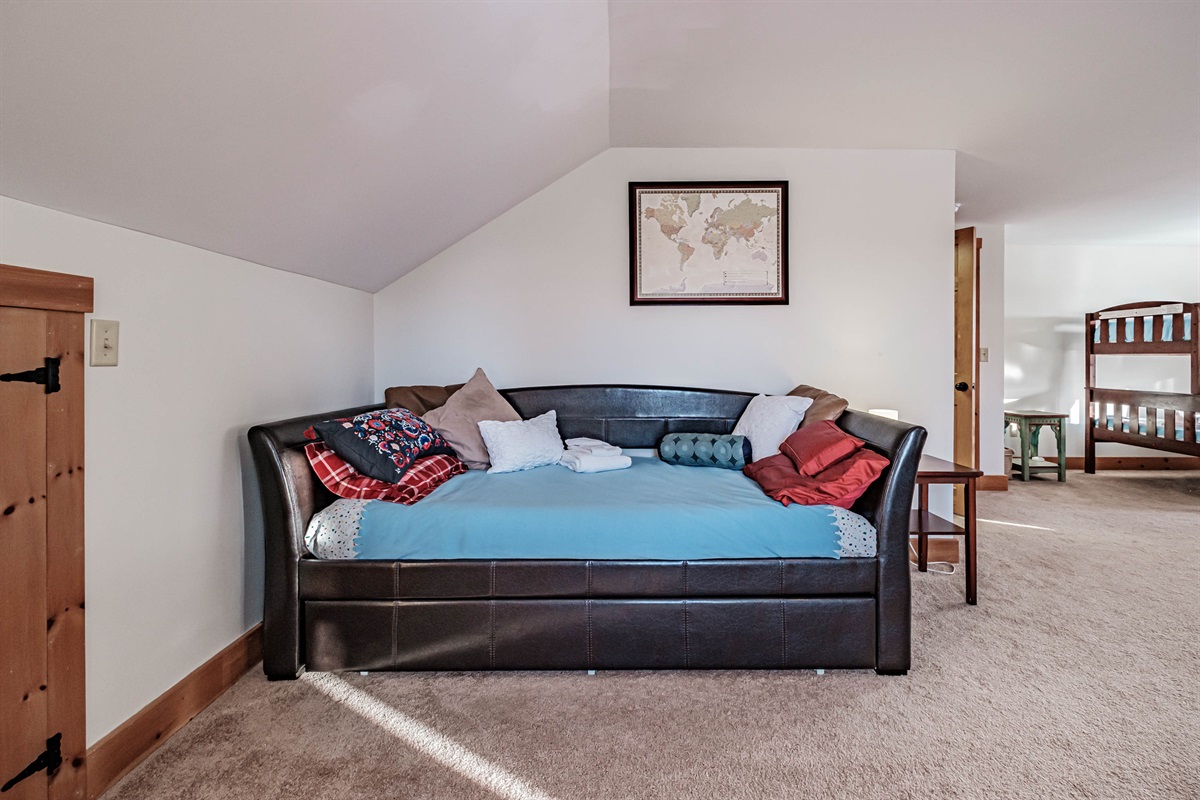 Bunk room with multiple beds for flexible accommodations.
