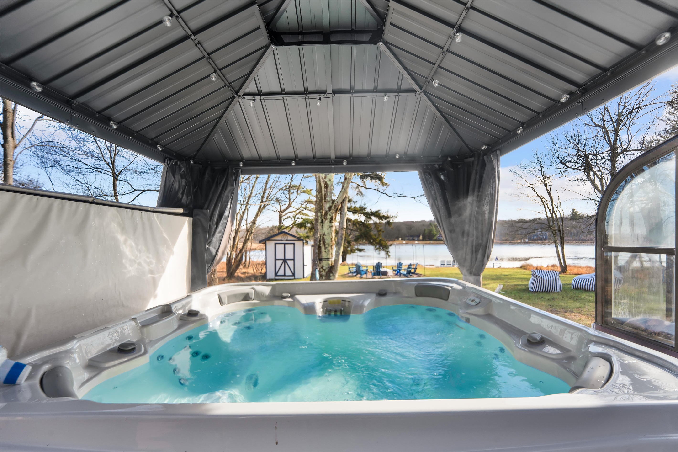 Warm up in the hot tub while winter unfolds around you