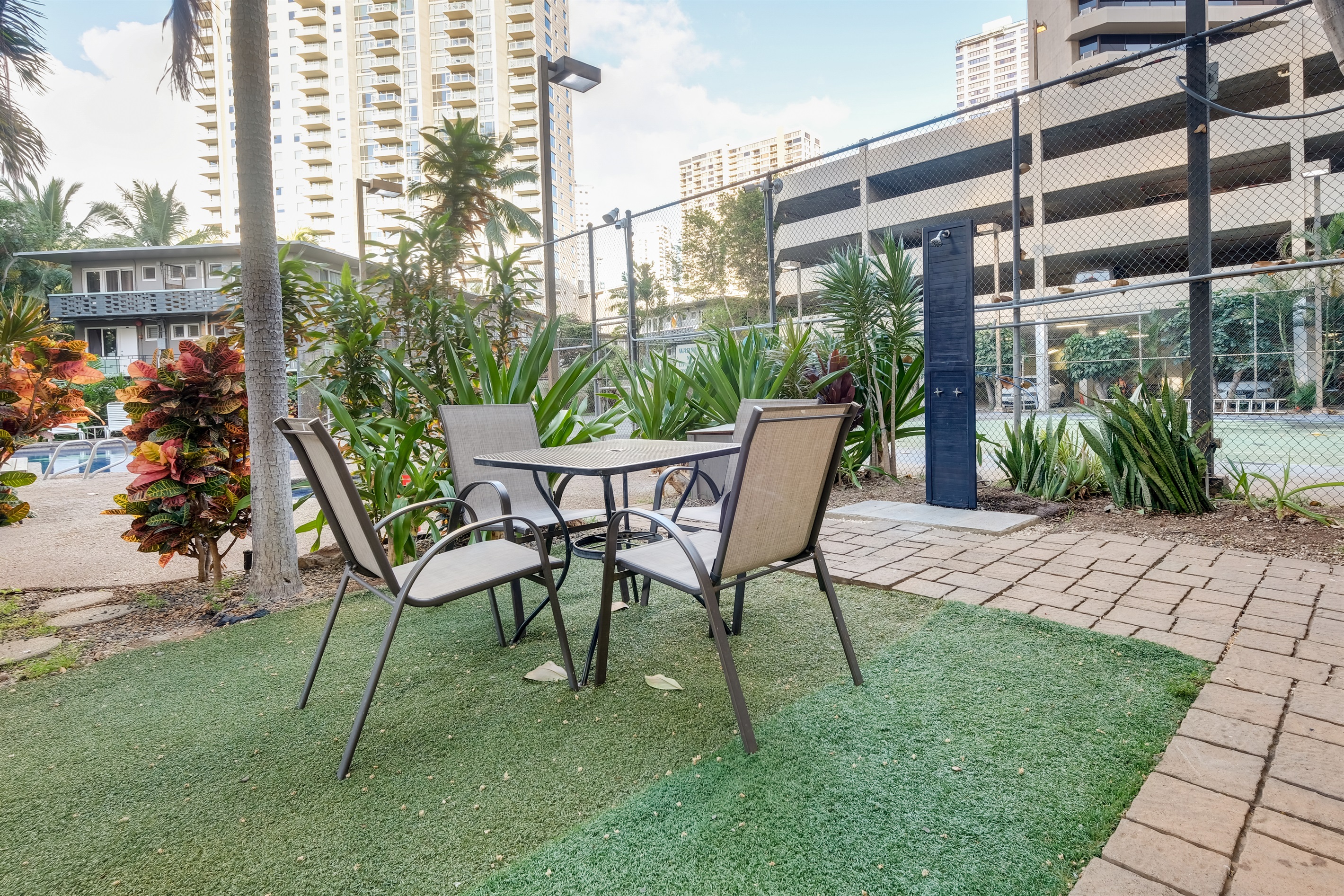 Enjoy outdoor dining surrounded by tropical palms and island breezes. This relaxing seating area near the pool is perfect for morning coffee, afternoon lunches, or sunset conversations in paradise