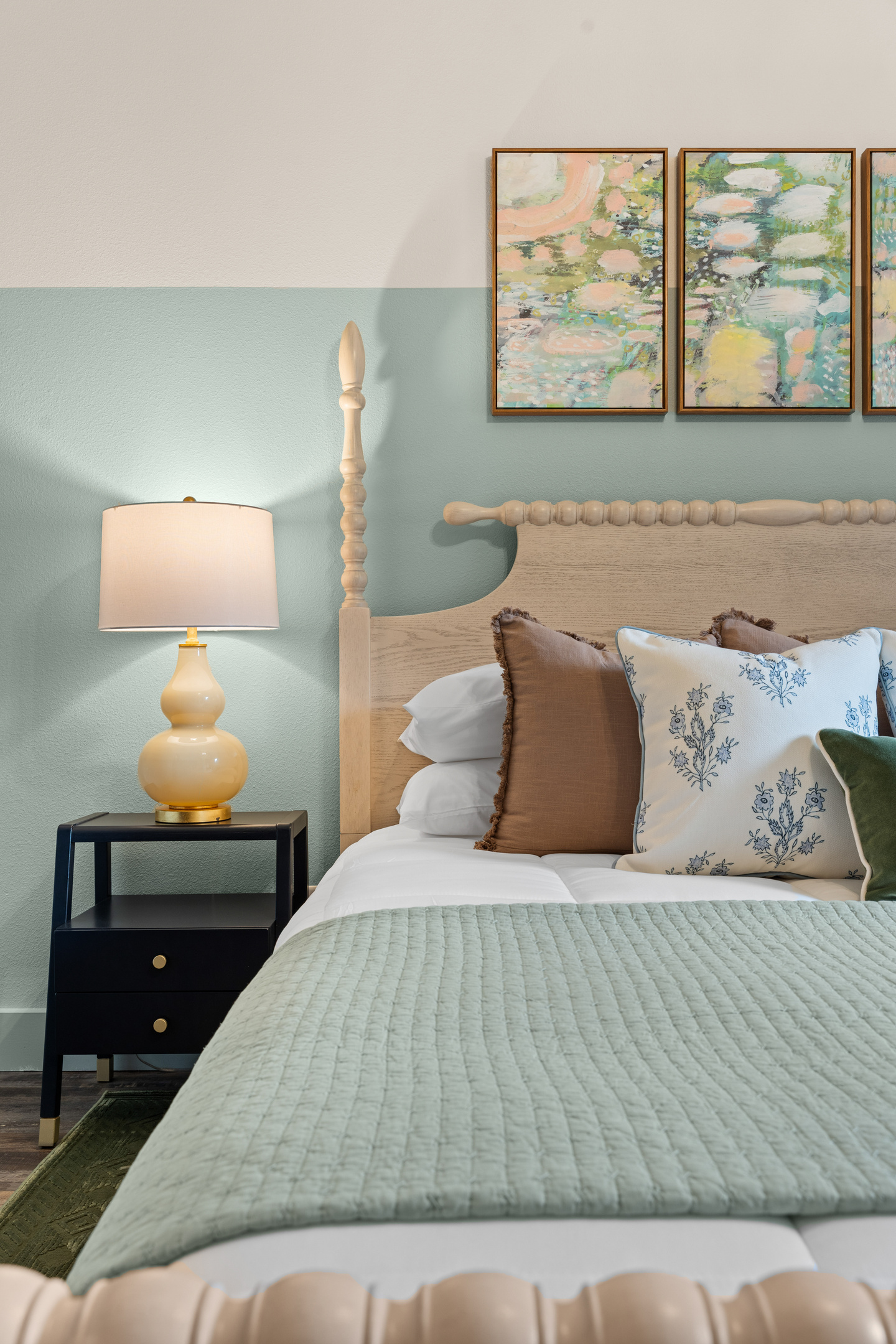 Unwind in the Bluebonnet Room beneath a spindle headboard and soft watercolor art.