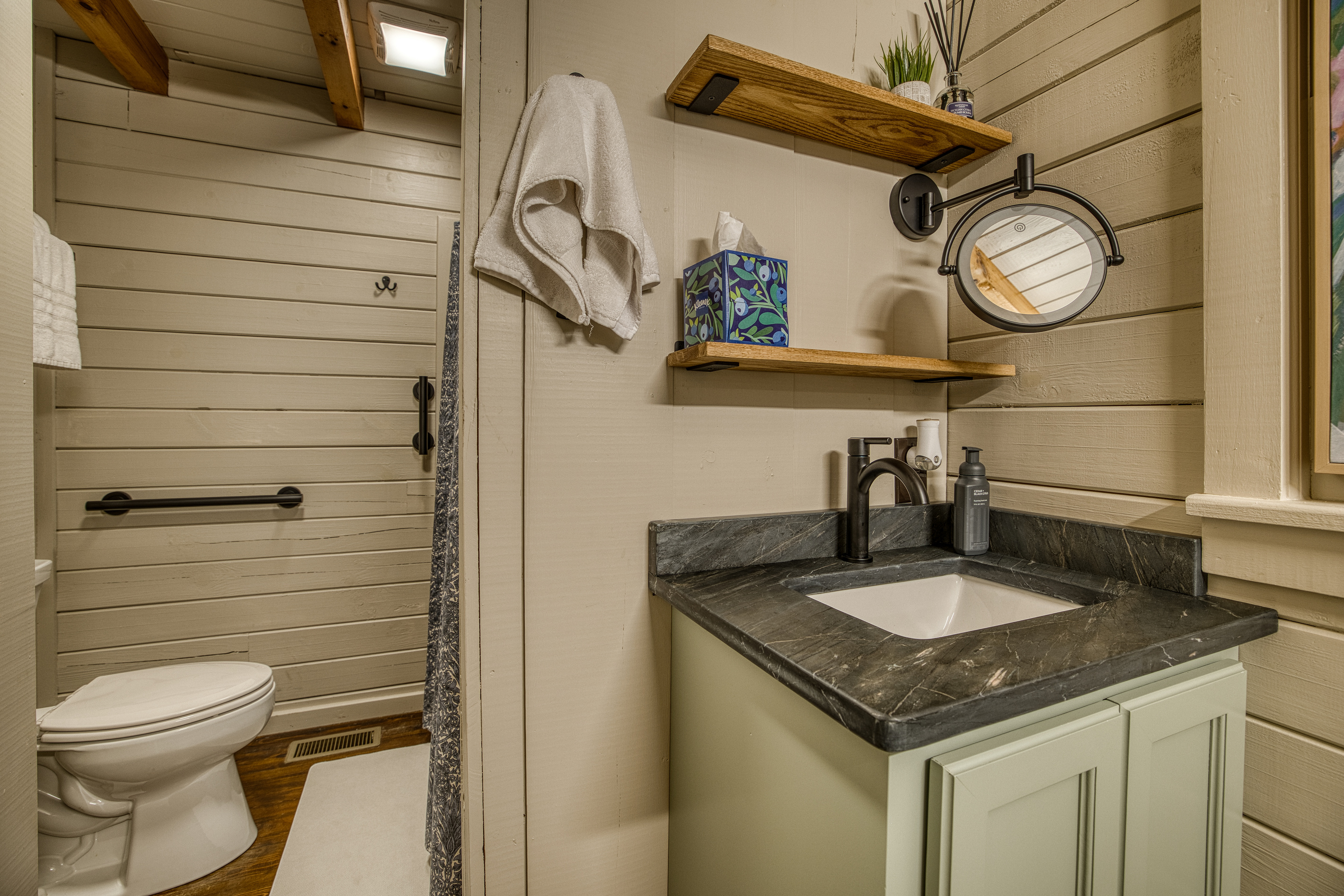 Bathroom with a vanity and open shelf.