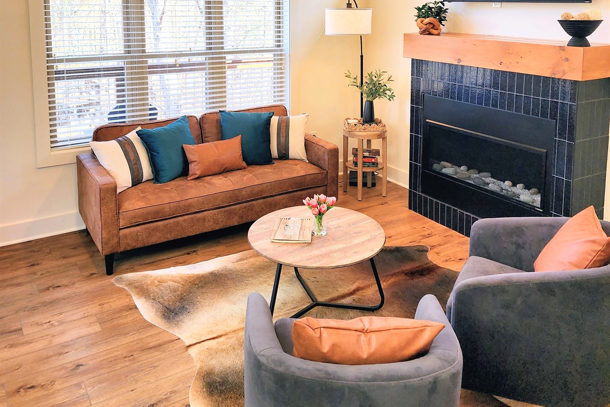Living room with Smart TV and fireplace - open concept connects to kitchen, modern furniture, cozy space to relax after a day at Dollywood or the Parkway.