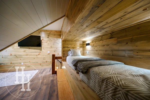 Two twin bunk beds with individual lights and plugs for electronics