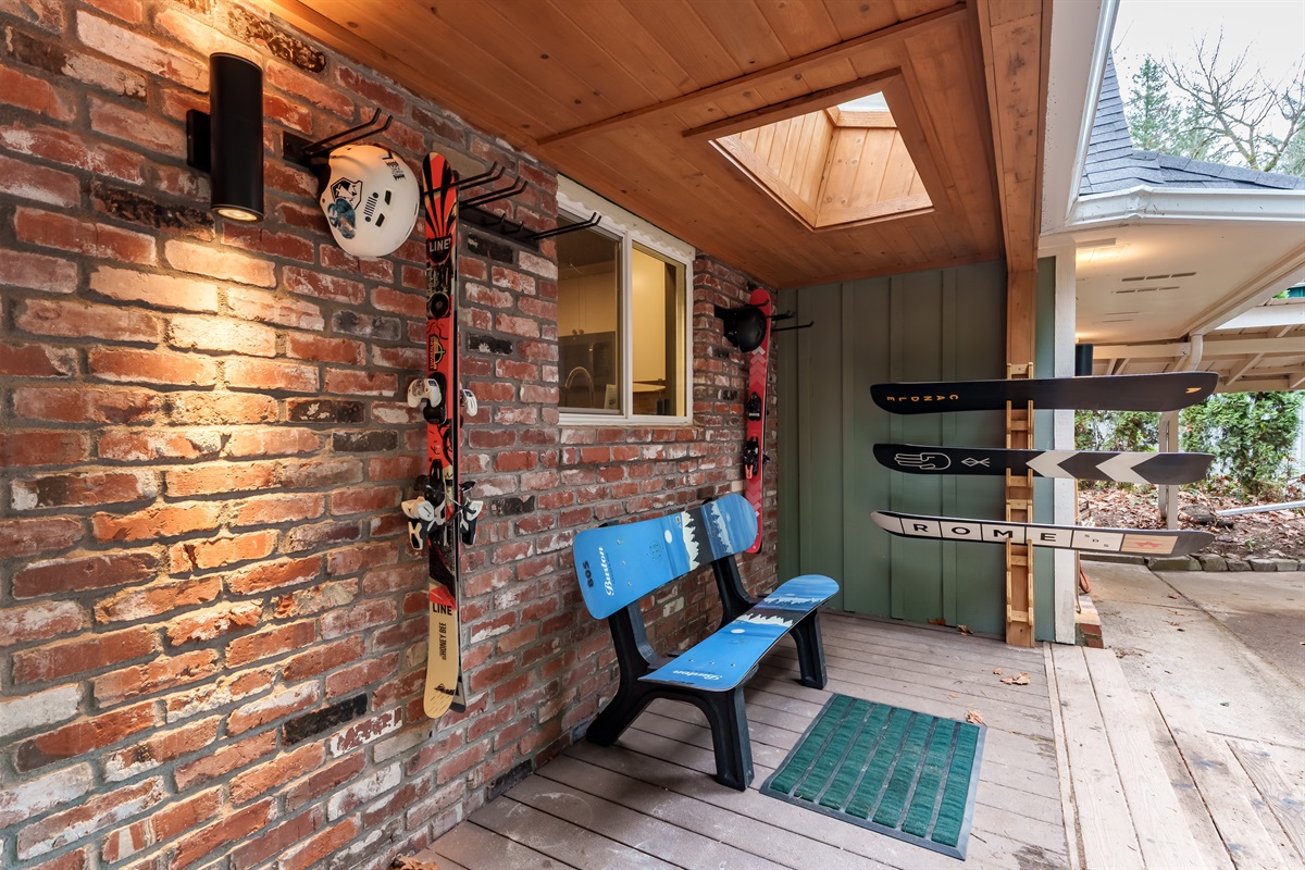 Gear up with ease on the front porch, featuring a fun snowboard bench and plenty of ski and snowboard storage—perfect for warming up or winding down after a day on the mountain.
