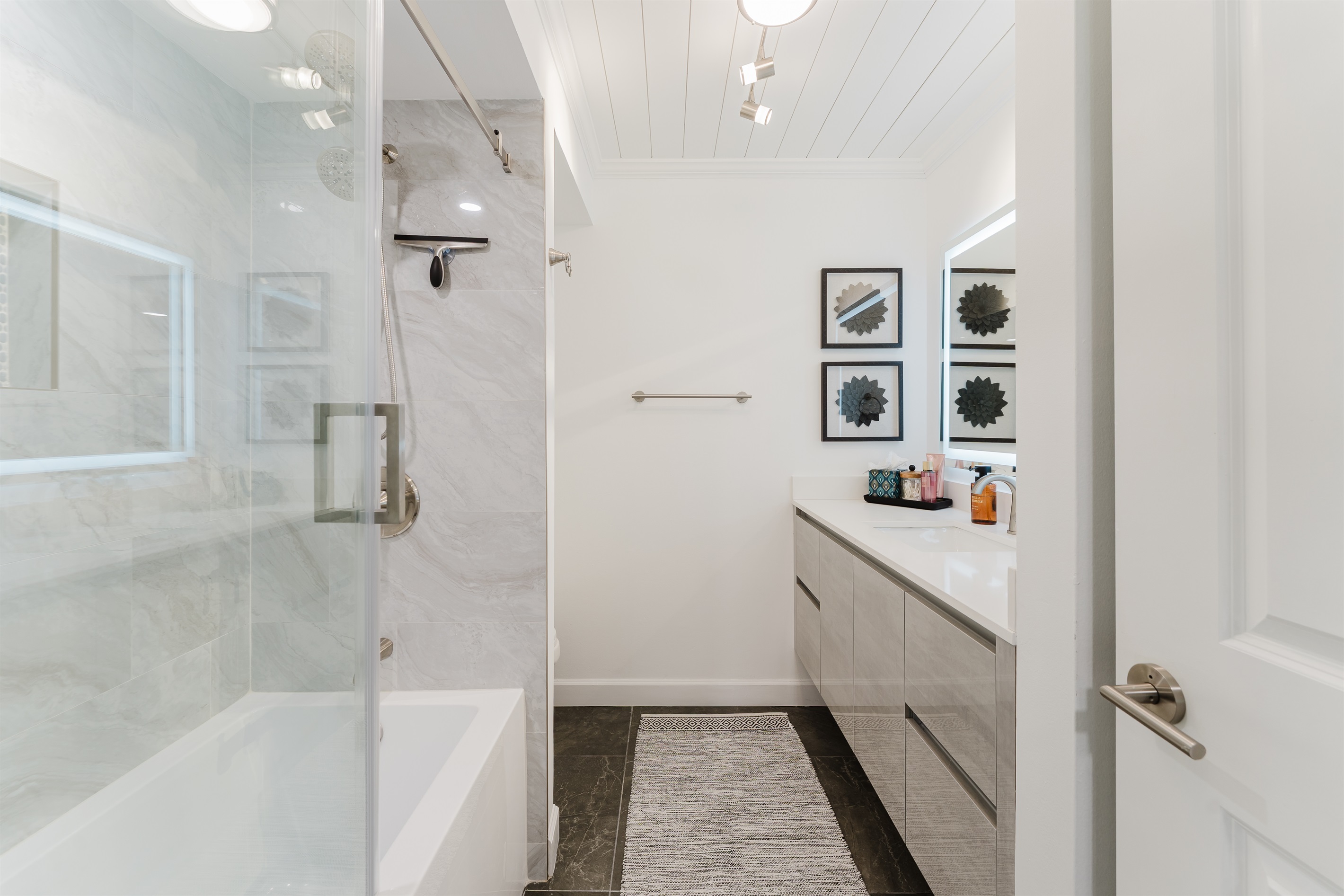 Clean, modern bathroom with fresh towels and essential amenities. Updated bathroom designed for comfort and convenience with a combination bath/shower. 
