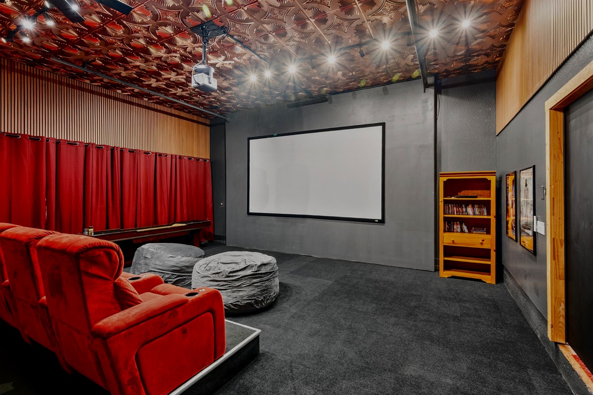 Movie nights come to life on the massive 155” screen powered by a Hisense PX3-Pro 4K Triple Laser Smart Projector, complete with Blu-ray player and movie collection.