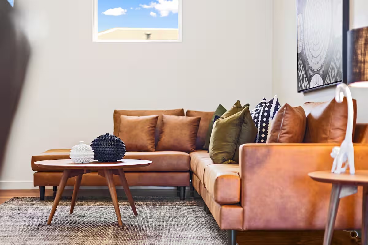 The lounge setting creates an easy place to pause inside Sasha’s Cottage on the Hill, with soft cushions and open living close by.