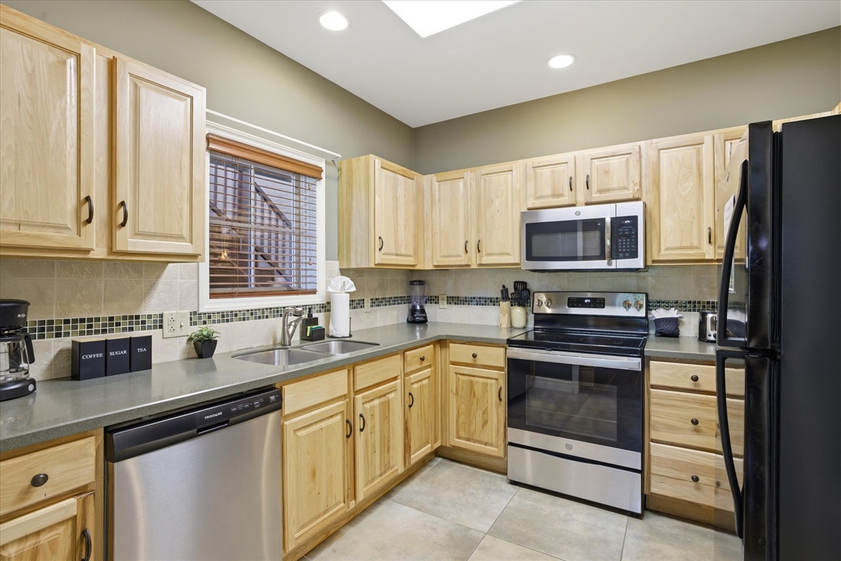 Cook, snack, or gather with your group in this fully equipped kitchen, stocked with everything you need and open to the main living space for easy connection.