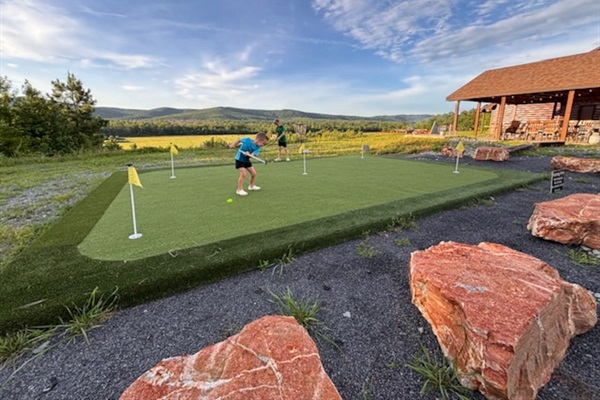 Putting green just steps from the cabin—practice anytime with scenic mountain views (guest photo - June 2025)