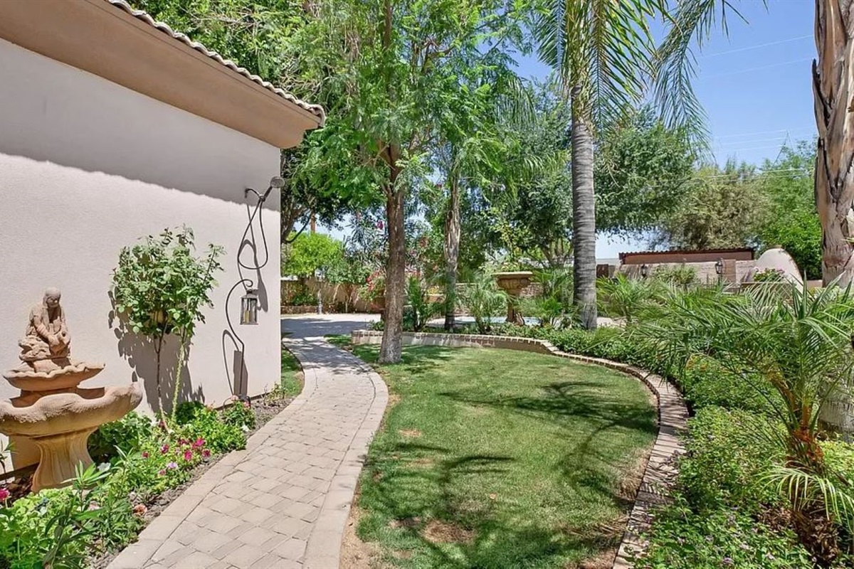 Stroll through this tranquil garden path framed by tropical greenery and desert charm, the perfect start to your peaceful escape.