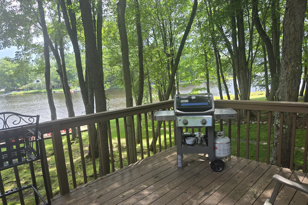 Deck with seating/table and BBQ grill, overlooking the lake