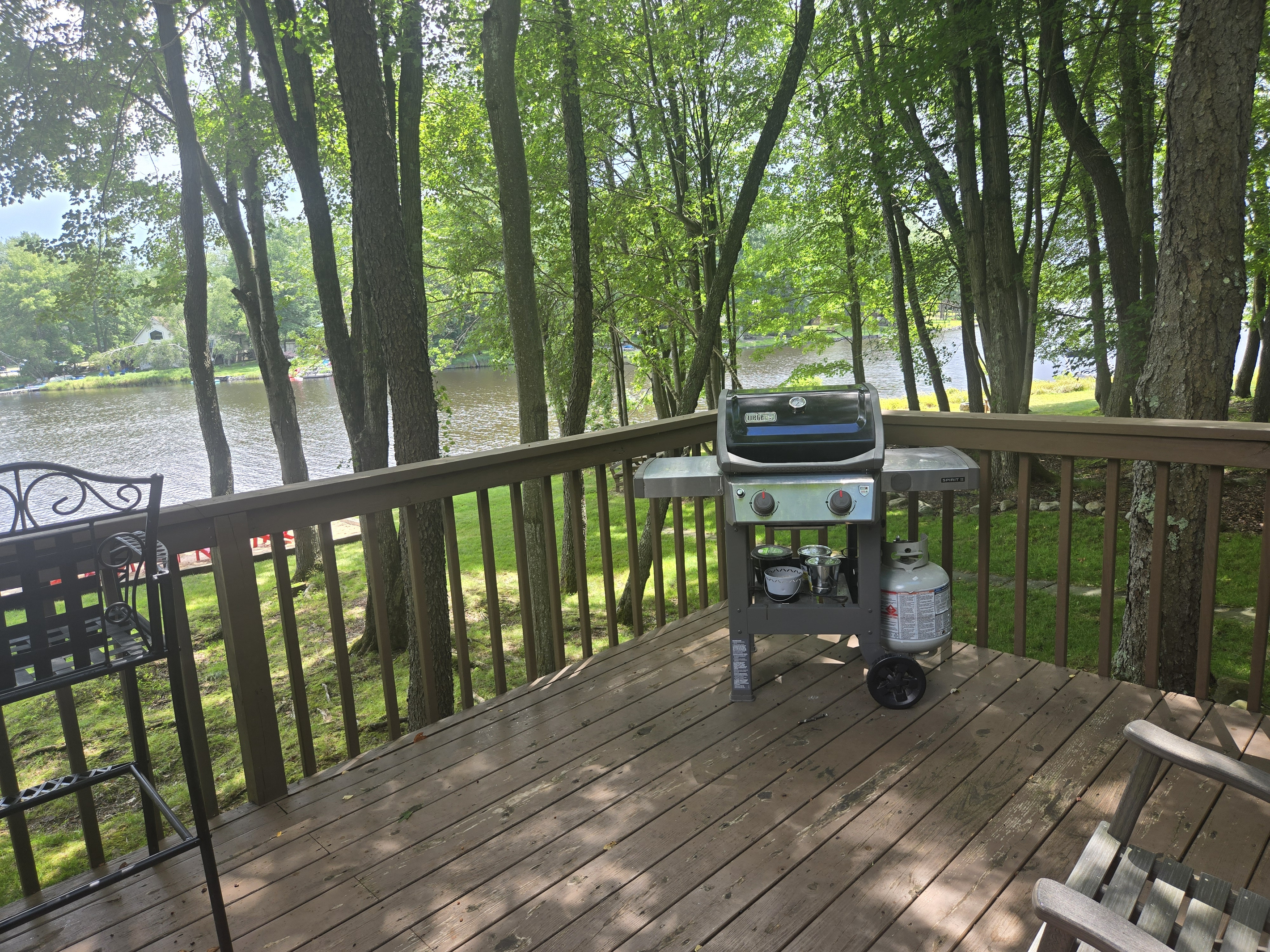 Deck with seating/table and BBQ grill, overlooking the lake