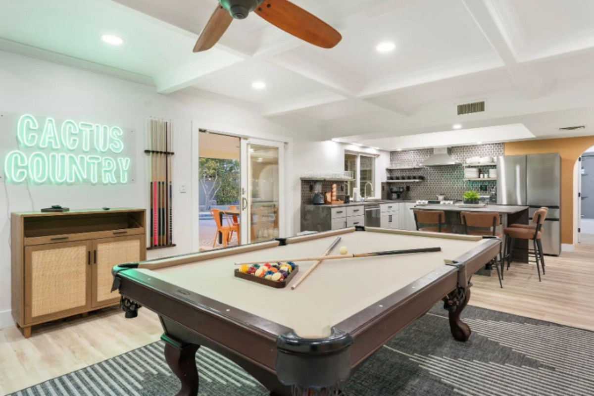 Another look at the game room shows the open flow between the pool table, kitchen, and lounge, easy sightlines for staying part of the group.
