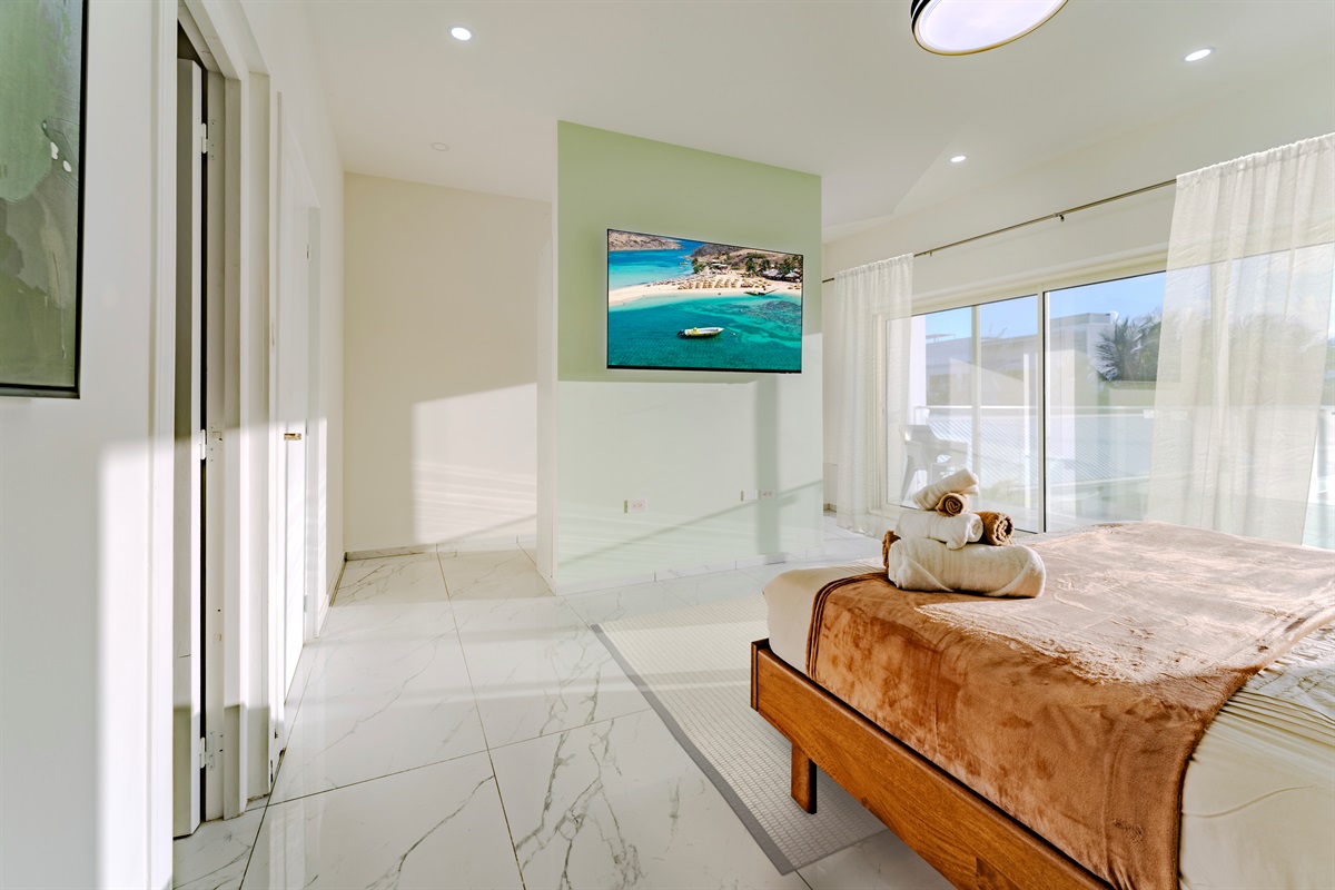 Bright Bedroom with King Bed, Wall‑Mounted TV & Floor‑to‑Ceiling Windows
