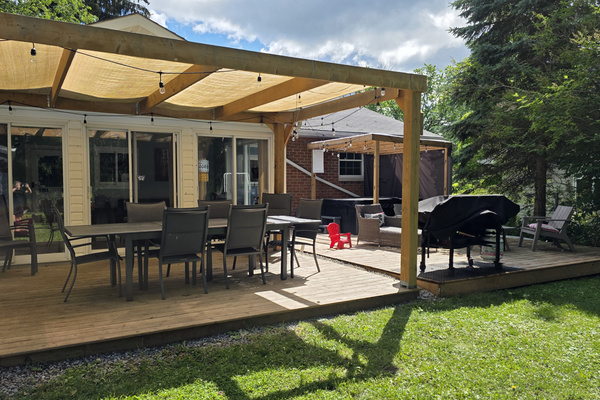 Spacious deck for every mood—grill, dine, lounge, or soak in the rain-proof hot tub.