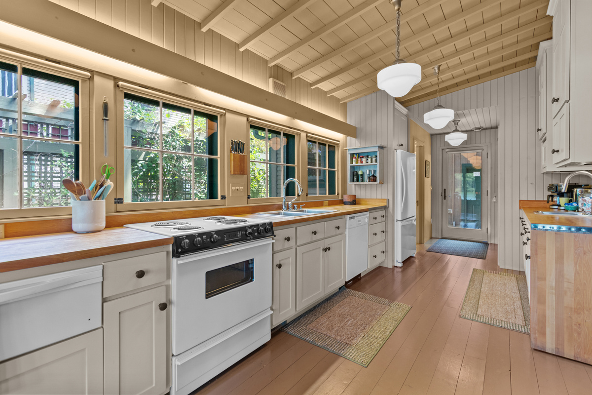 With plenty of room to cook and gather, the spacious kitchen is made even more inviting by the warm glow of beautiful lighting overhead.
