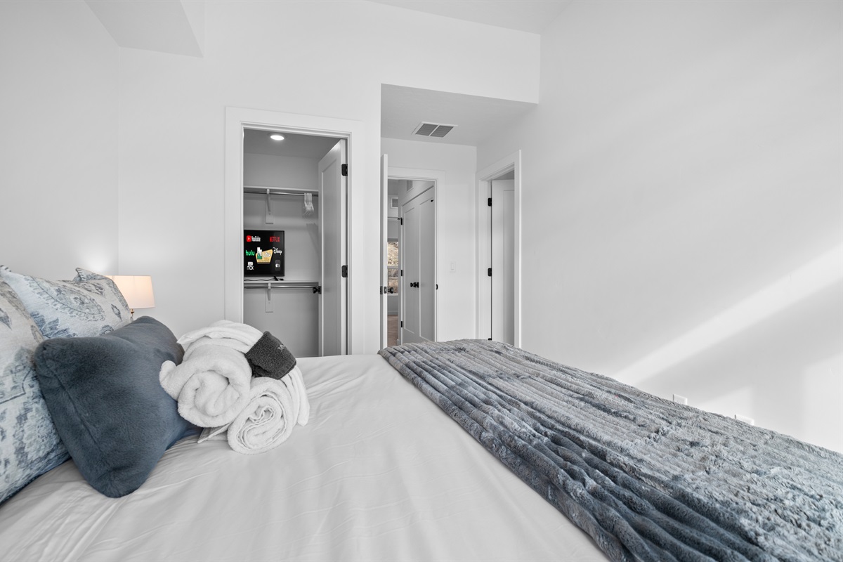 Bright upstairs guest bedroom with comfortable bedding.