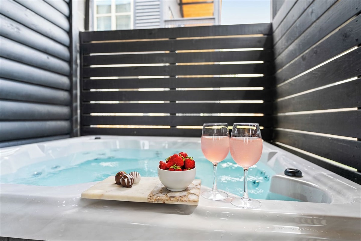 Lower level has a private hot tub, bar stools/ chairs, and conversational seating. Plenty of space for everyone to relax and enjoy!