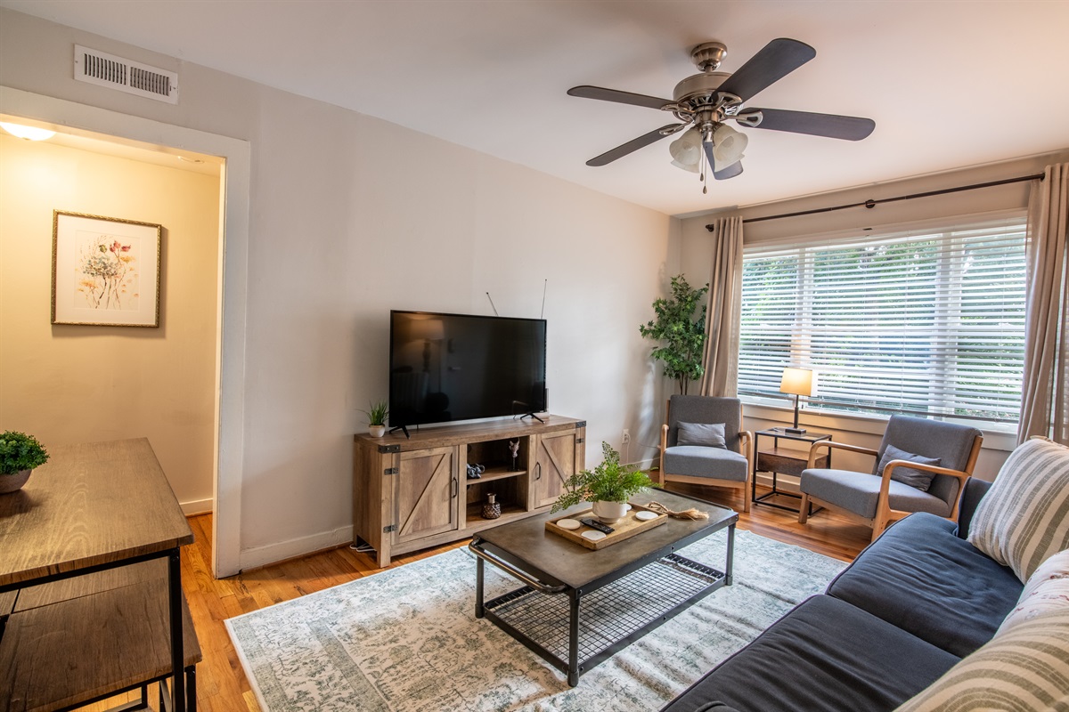 Welcoming entry to the living room featuring stylish wall art, warm tones, and an inviting atmosphere.