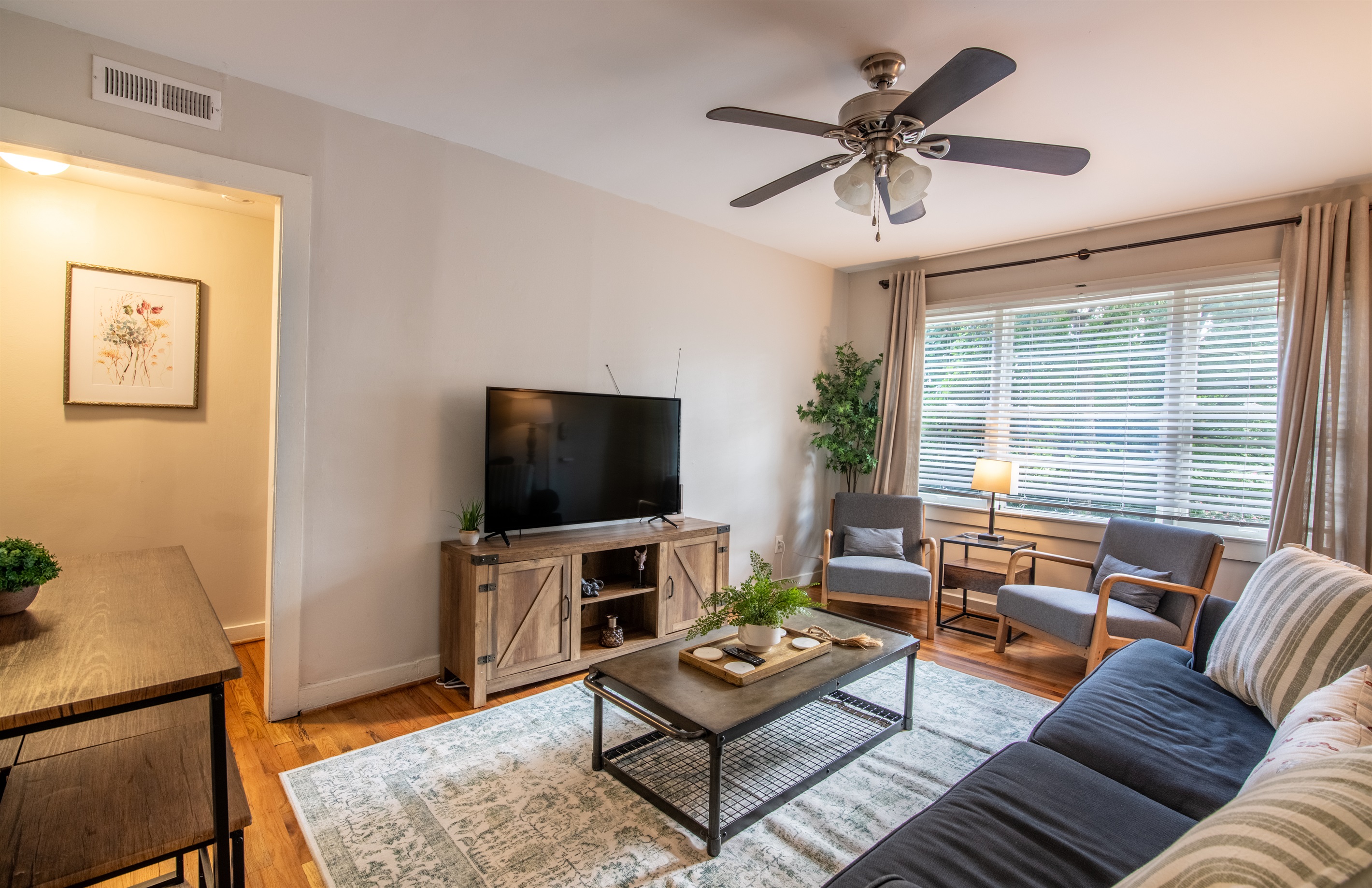 Welcoming entry to the living room featuring stylish wall art, warm tones, and an inviting atmosphere.