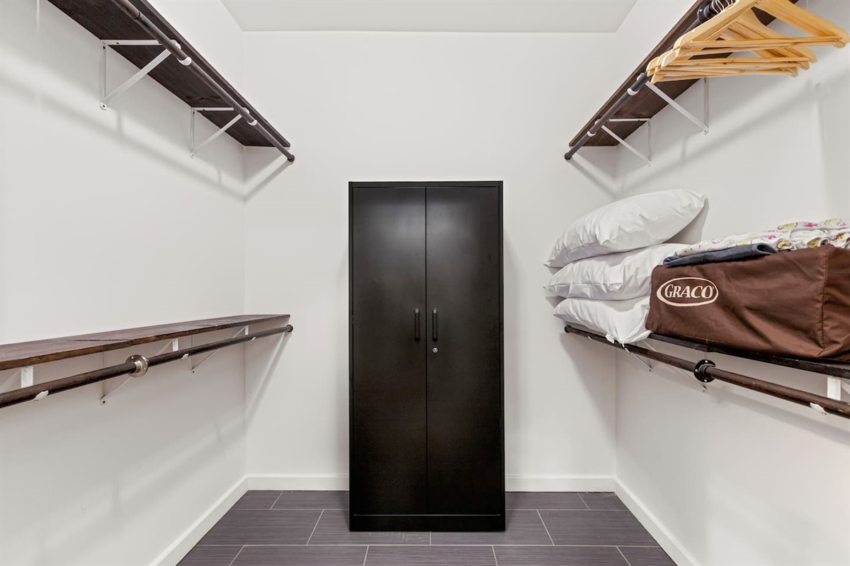 Find ample storage for all your essentials in our clean and organized closet space, ensuring a clutter-free stay. We store our pack 'n play in this primary en suite closet and this cabinet stays locked for owner's storage.