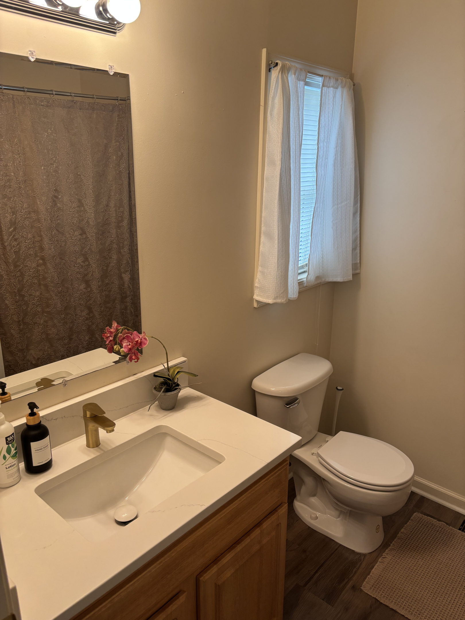 Private Primary en-suite bathroom with a quartz-topped vanity and full bath.