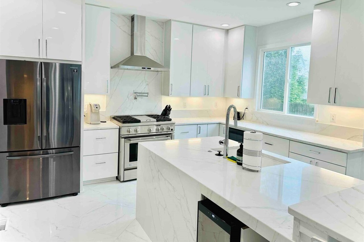 Chef's kitchen comes complete with everything you need for cooking a delicious meal. Stainless steel appliances, gas range, ice maker, and wine fridge.