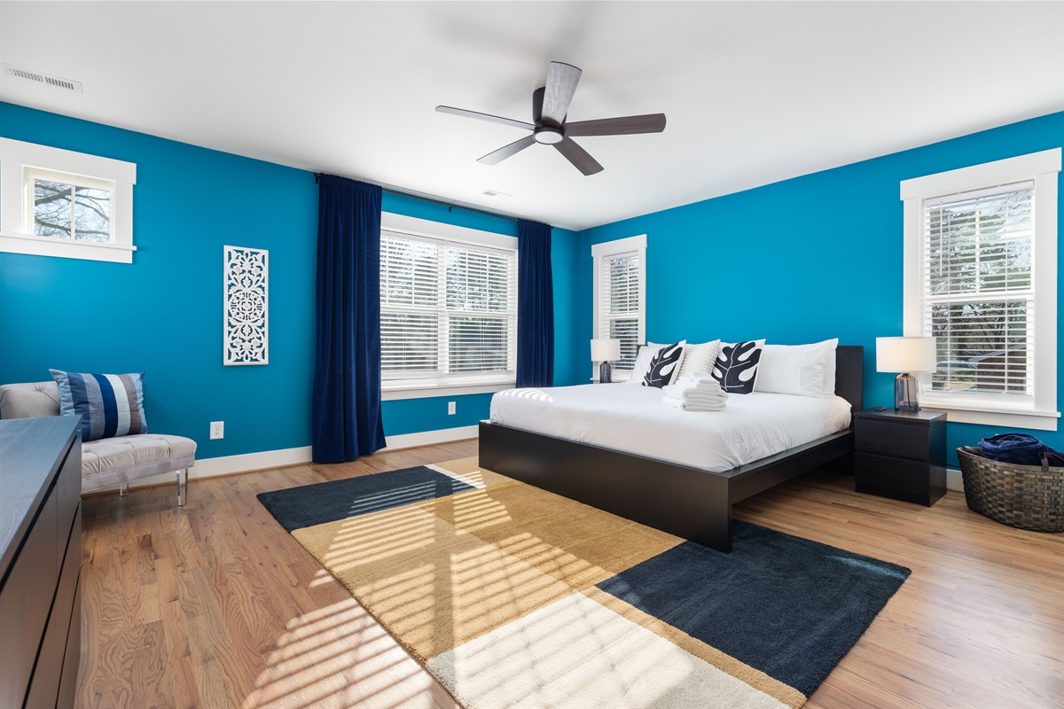 The primary bedroom with king-sized bed for a restful night's sleep. Watch all of your favorite TV shows from bed on the 65" smart TV. 