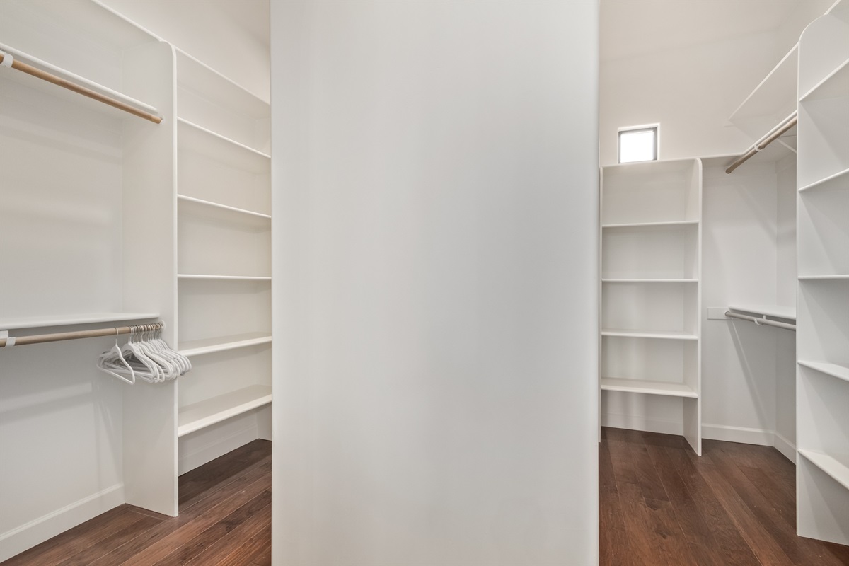 generous his-and-hers primary walk in closet