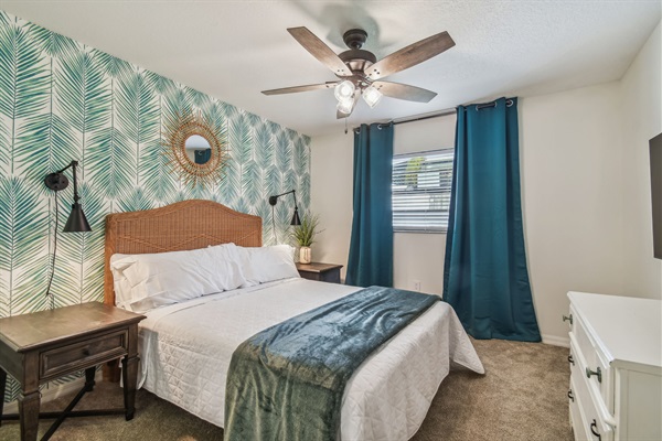 The Green Palm Bedroom features a queen bed, full closet, blackout curtains, and 50" smart TV.