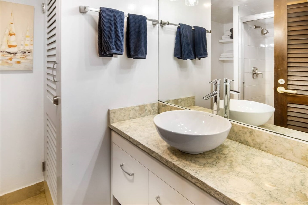 The first floor, full bathroom, to the left of the front door.